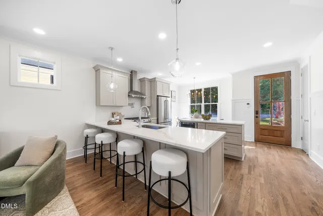 a kitchen with granite countertop a sink appliances and cabinets