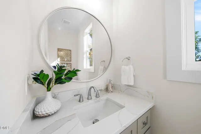 a kitchen with a sink a stove a dining table and chairs