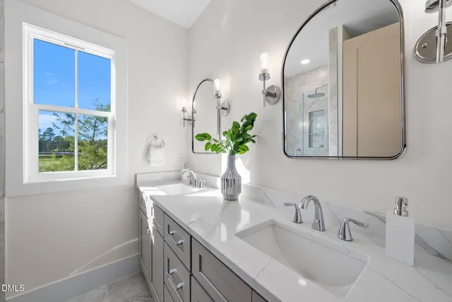 a bathroom with a granite countertop toilet sink and mirror