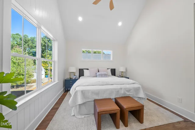 a bed sitting in a bedroom next to a window
