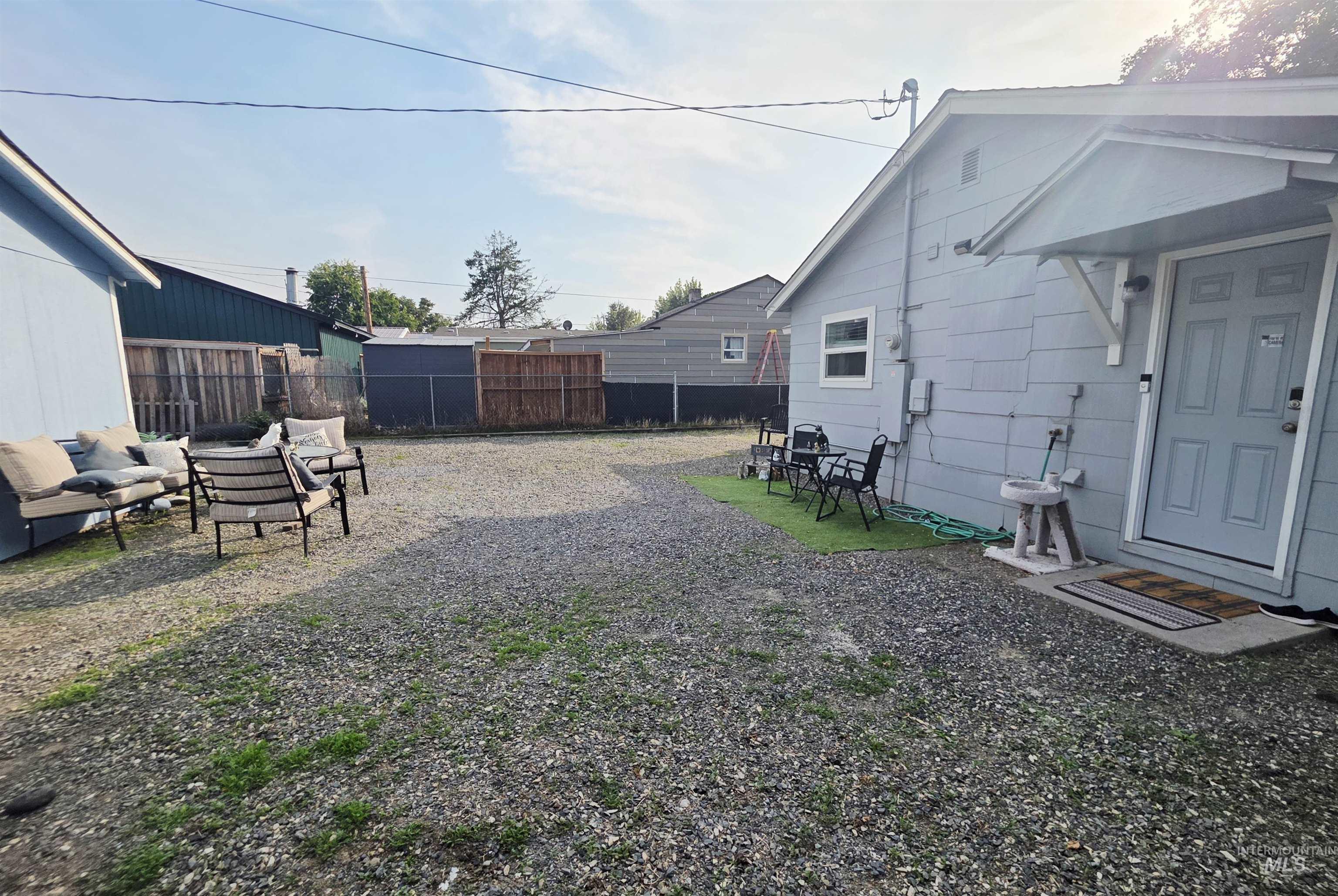 409 8th Street Clarkston, WA 99403 - Photo 13 of 23 Gravel lot with partial fencing and an exterior door
