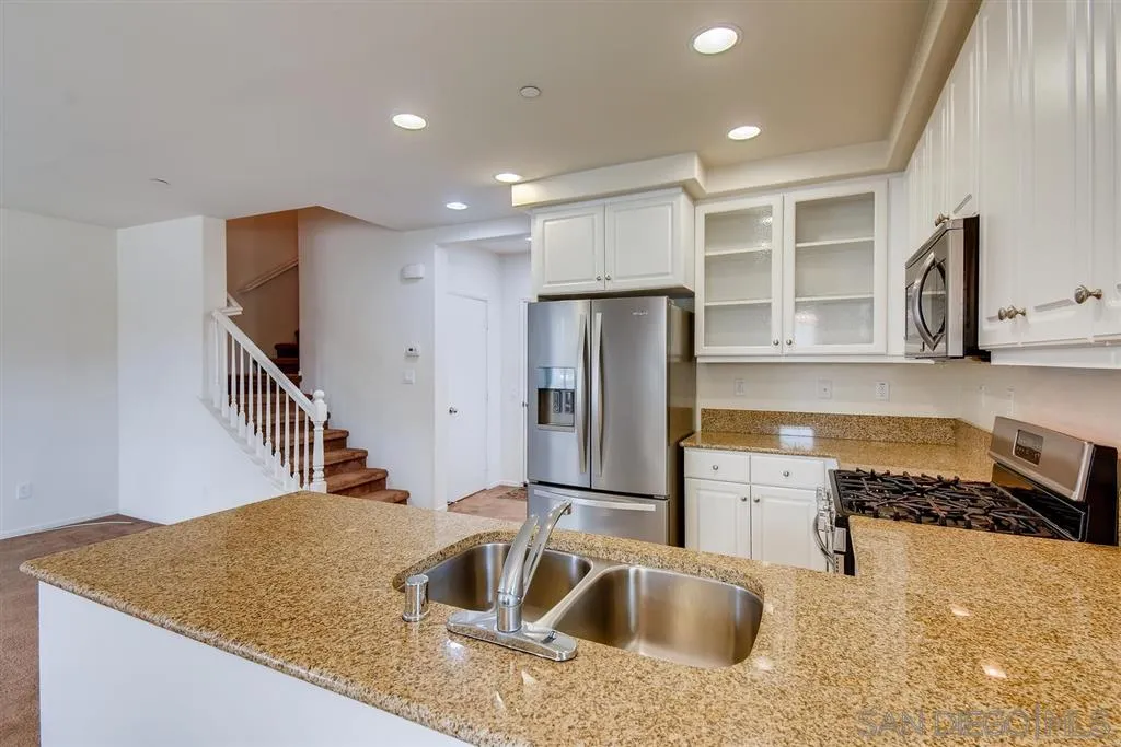 1435 Santa Diana Road, Unit 9 Chula Vista, CA 91913 - Photo 8 of 23 a kitchen with stainless steel appliances granite countertop a sink and a refrigerator