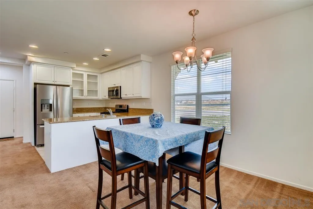 1435 Santa Diana Road, Unit 9 Chula Vista, CA 91913 - Photo 10 of 23 a view of a dining room with furniture window and wooden floor