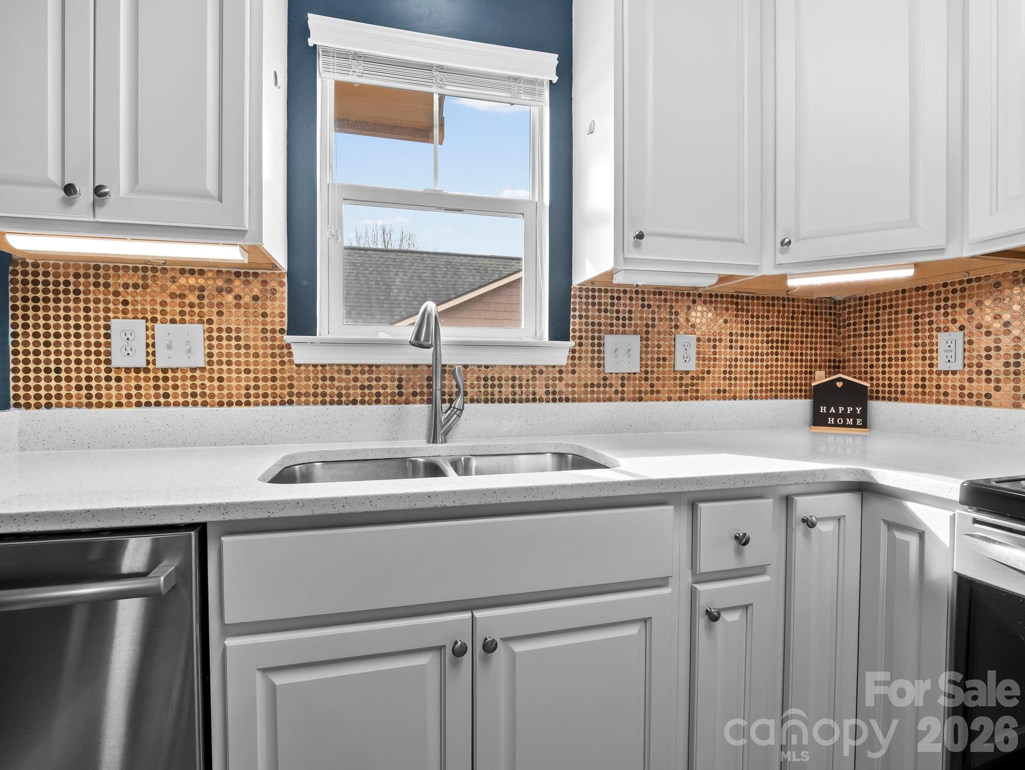 1002 Deermouse Way Hendersonville, NC 28792 - Photo 14 of 42 a kitchen with a sink cabinets and window