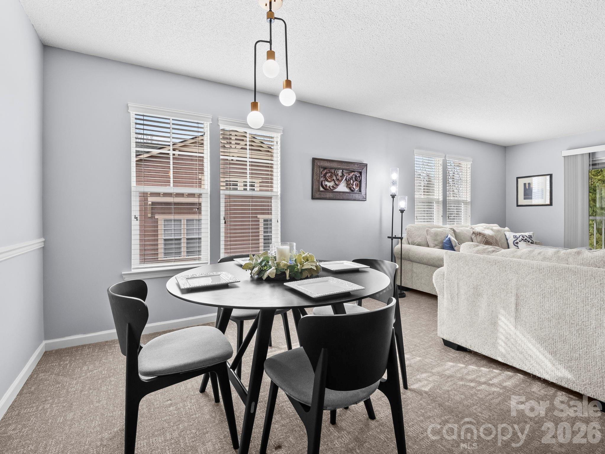 1002 Deermouse Way Hendersonville, NC 28792 - Photo 16 of 42 a view of a dining room with furniture window and wooden floor