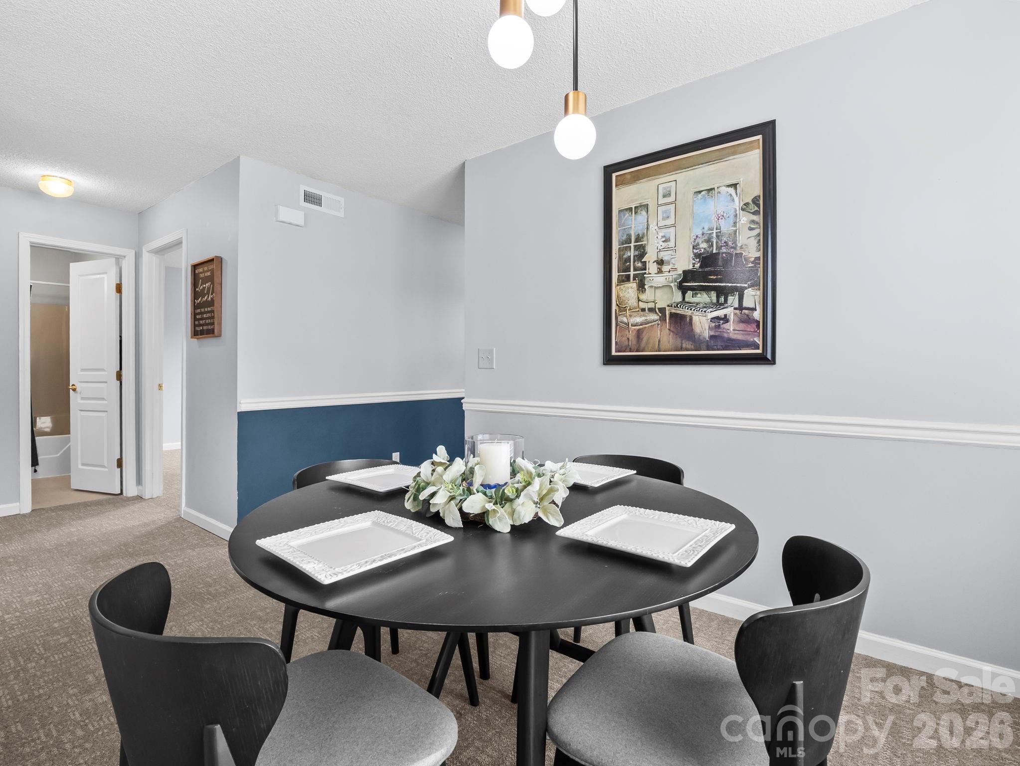 1002 Deermouse Way Hendersonville, NC 28792 - Photo 17 of 42 a view of a dining room with furniture and wooden floor