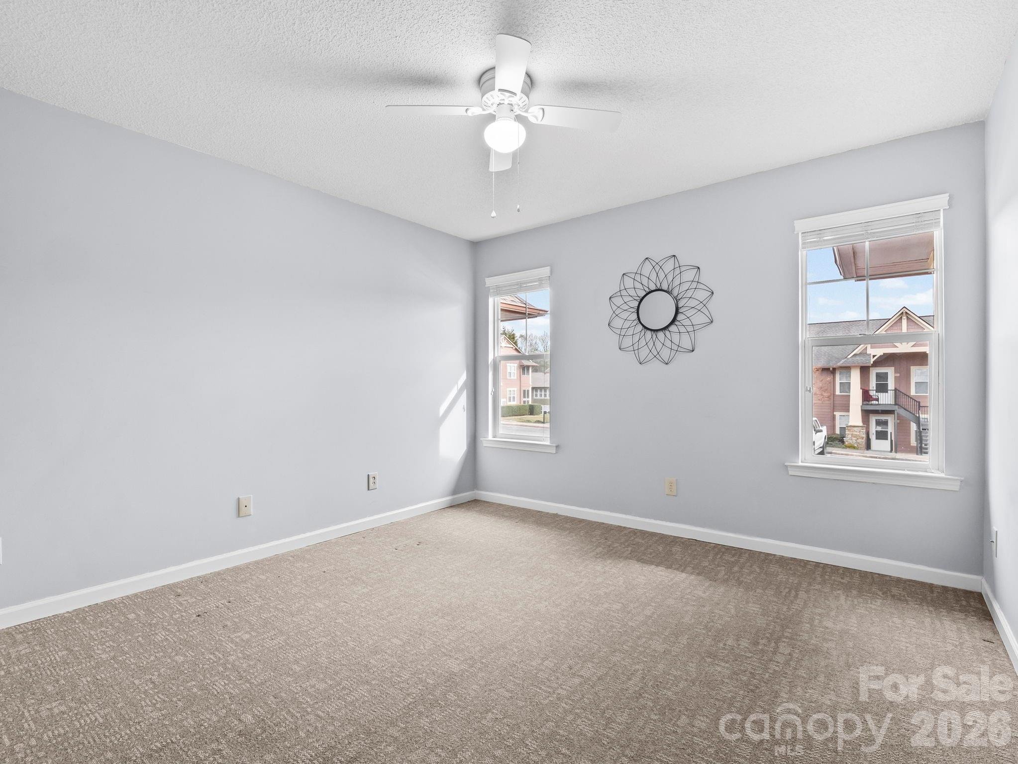 1002 Deermouse Way Hendersonville, NC 28792 - Photo 24 of 42 an empty room with windows and fan