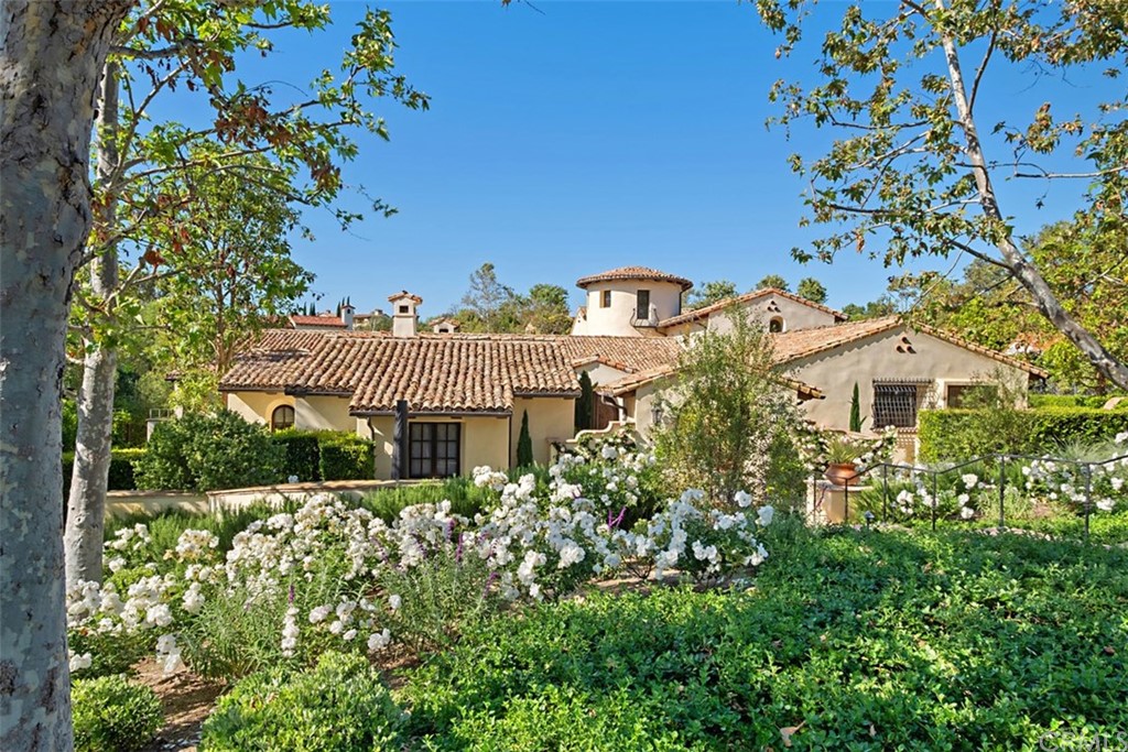 view of a house with a yard and garden