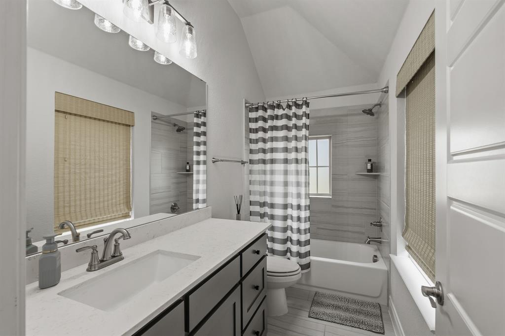 11504 Antler Ridge Way Argyle, TX 76226 - Photo 8 of 40 Ensuite bathroom for bedroom #2. Tons of light with two windows in the bathroom. Extra long vanity for extra space and storage.