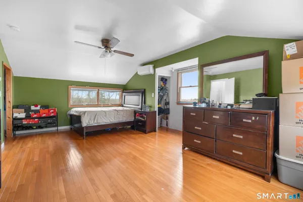 a bedroom with a bed and a large mirror
