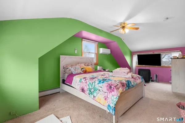 a bedroom with a bed a flat screen tv and a bed