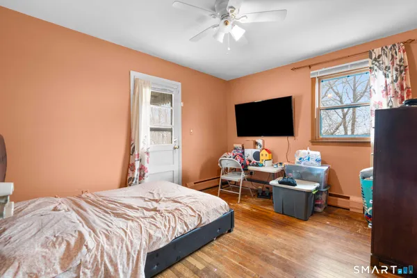 a bedroom with furniture and a flat screen tv