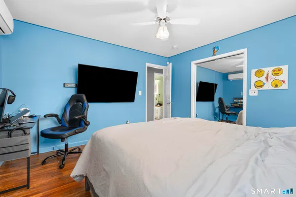 a bedroom with a bed and a flat screen tv