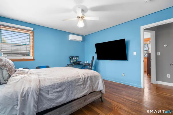 a bedroom with a bed and a flat screen tv