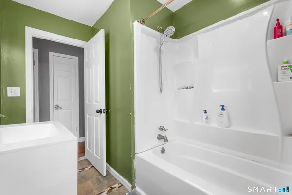 a bathroom with a bathtub and a shower