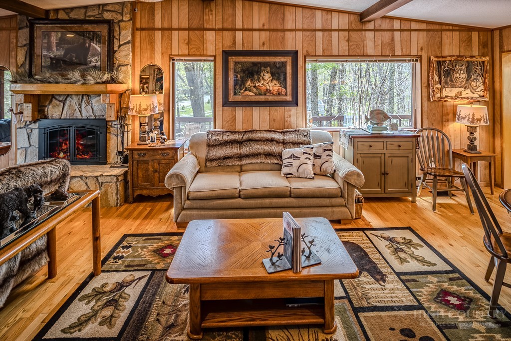 103-105 Upper Grouse Ridge Road Beech Mountain, NC 28604 - Photo 14 of 48 a living room with furniture a fireplace and windows