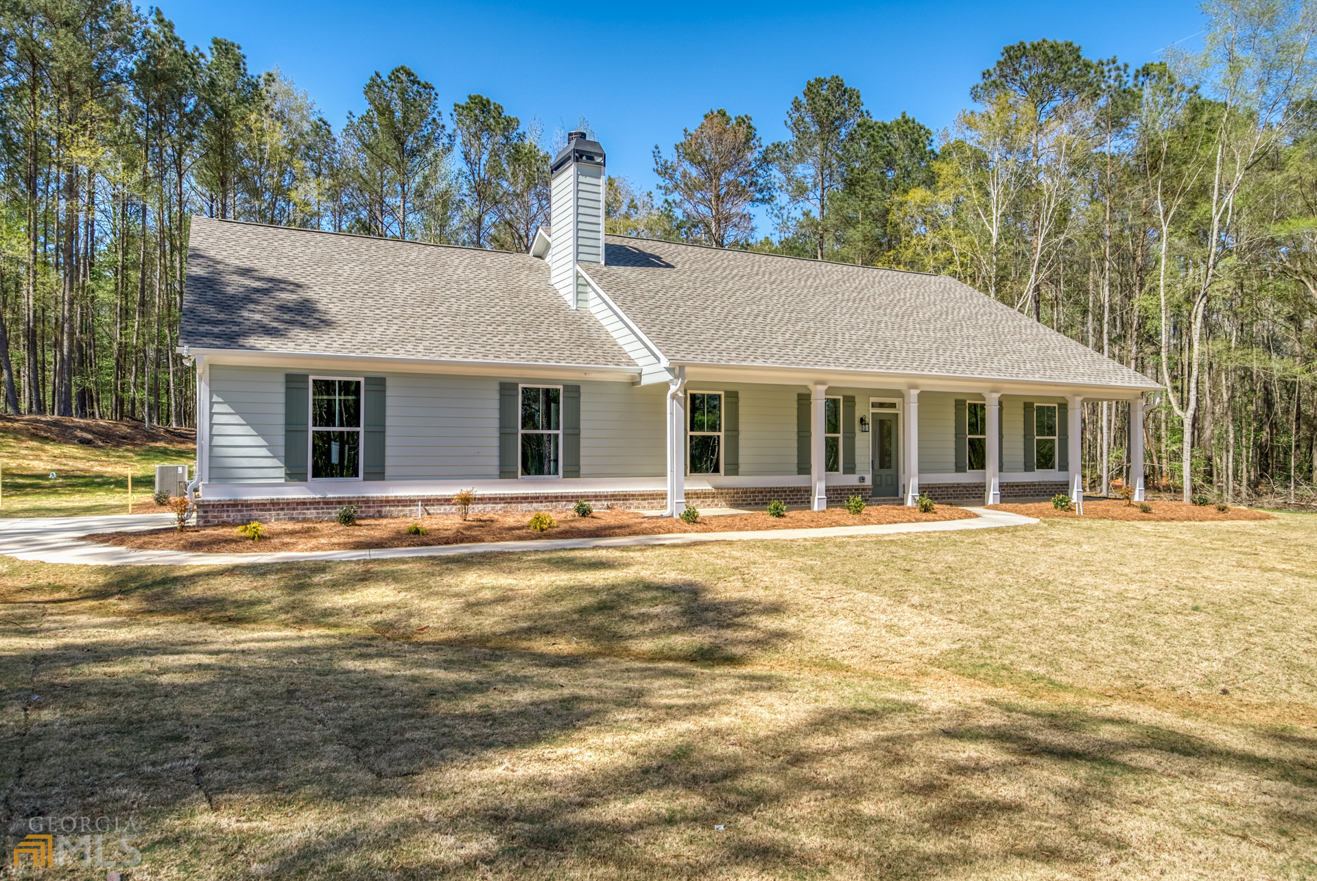 a front view of a house with a yard and swimming pool