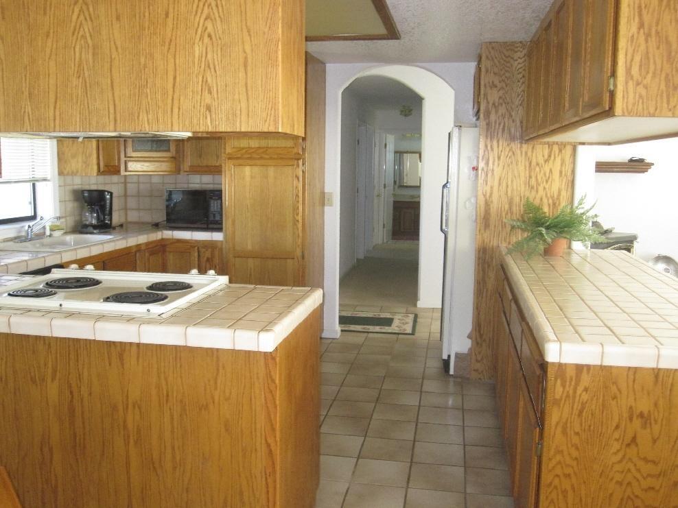 45541 Pittville Road McArthur, CA 96056 - Photo 19 of 26 a kitchen with a sink a refrigerator and a stove