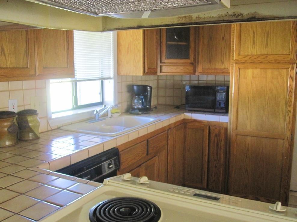 45541 Pittville Road McArthur, CA 96056 - Photo 20 of 26 a kitchen with stainless steel appliances granite countertop a sink stove and cabinets