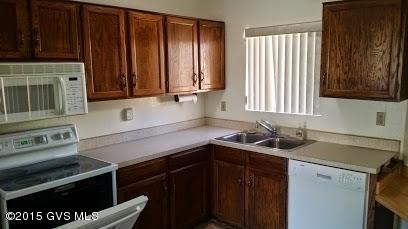 622 West Rio San Pedro Green Valley, AZ 85614 - Photo 2 of 16 a kitchen with granite countertop a sink stove and microwave
