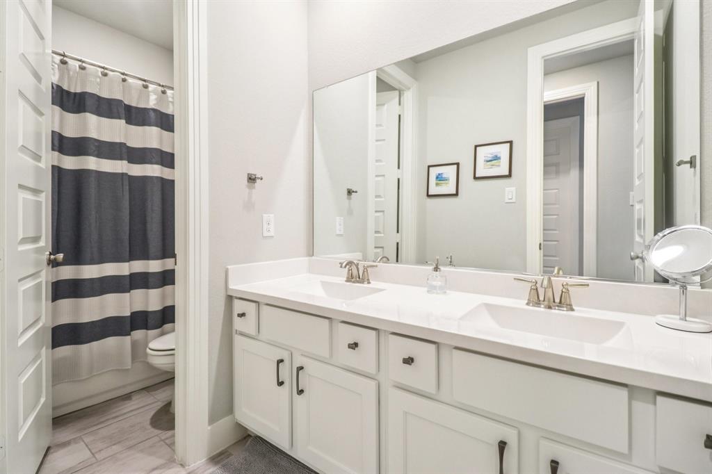 847 Longbranch Way Little Elm, TX 76227 - Photo 22 of 39 Full bathroom with double vanity, a shower with shower curtain, and wood finished floors