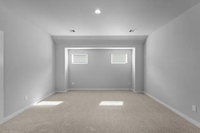 an empty room with a empty space and a window