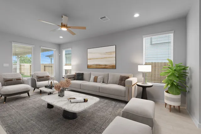 a living room with furniture potted plant and a window