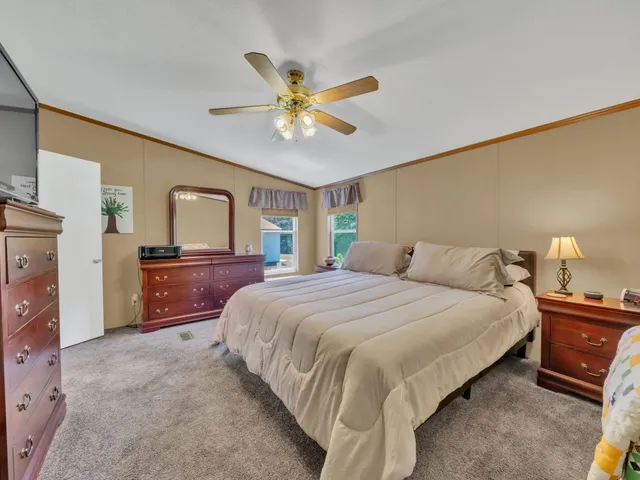 a bedroom with a bed and a large window