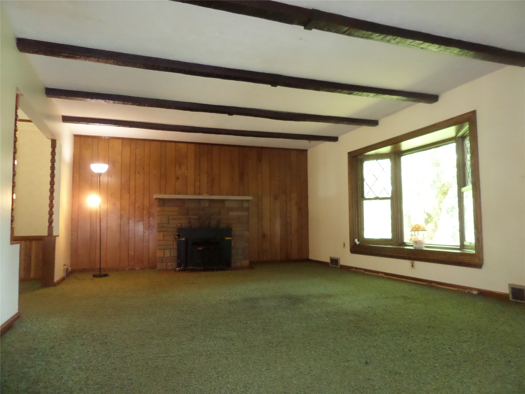 8920 Lake Pleasant Road Erie, PA 16509 - Photo 10 of 19 LIVING ROOM HAS A WOODBURNING FIREPLACE. ROOM WOULD SHOW BETTER WITH NEWER CARPETING.