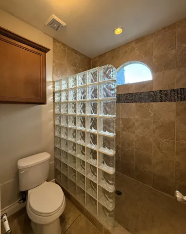 a bathroom with a toilet and a shower