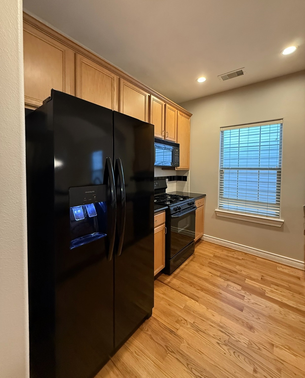 2939 Clinton Drive Houston, TX 77020 - Photo 7 of 20 a kitchen with stainless steel appliances a refrigerator and a stove top oven