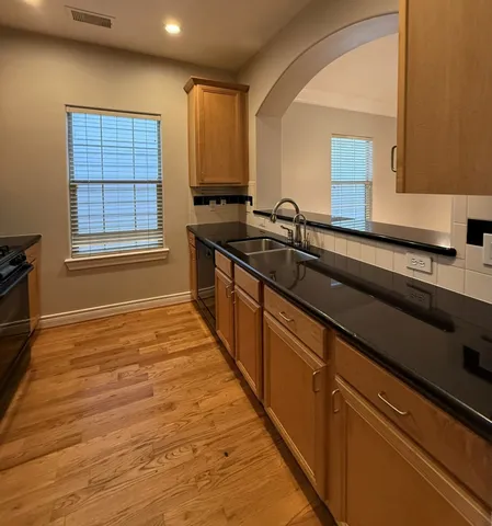 a bathroom with a sink a mirror and a window