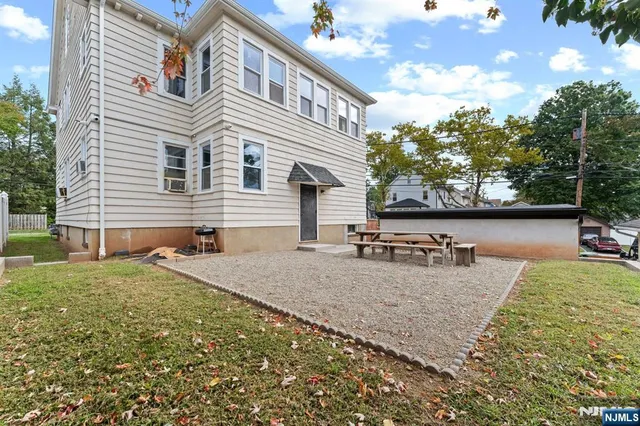 a backyard of a house with wooden floor and outdoor seating
