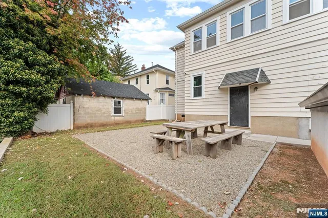 a backyard of a house with table and chairs
