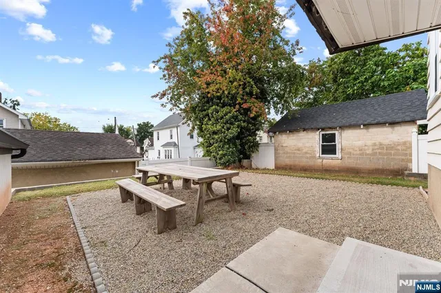 a backyard of a house with yard and outdoor seating
