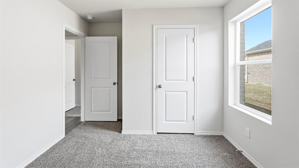3519 Spring Time Street Forney, TX 75126 - Photo 7 of 37 Interior room with light gray walls, gray carpet, and white baseboards