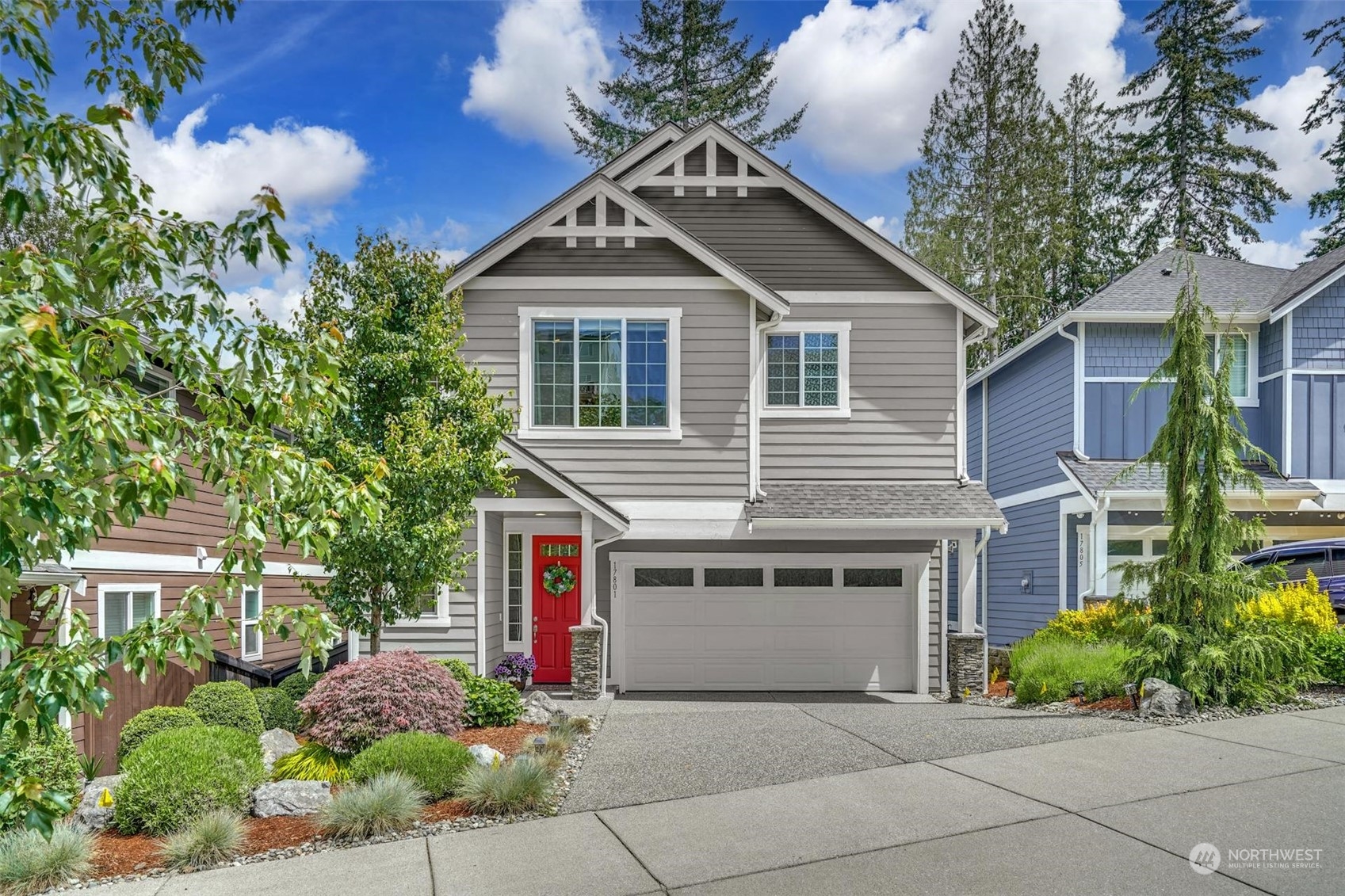 a front view of a house with plants