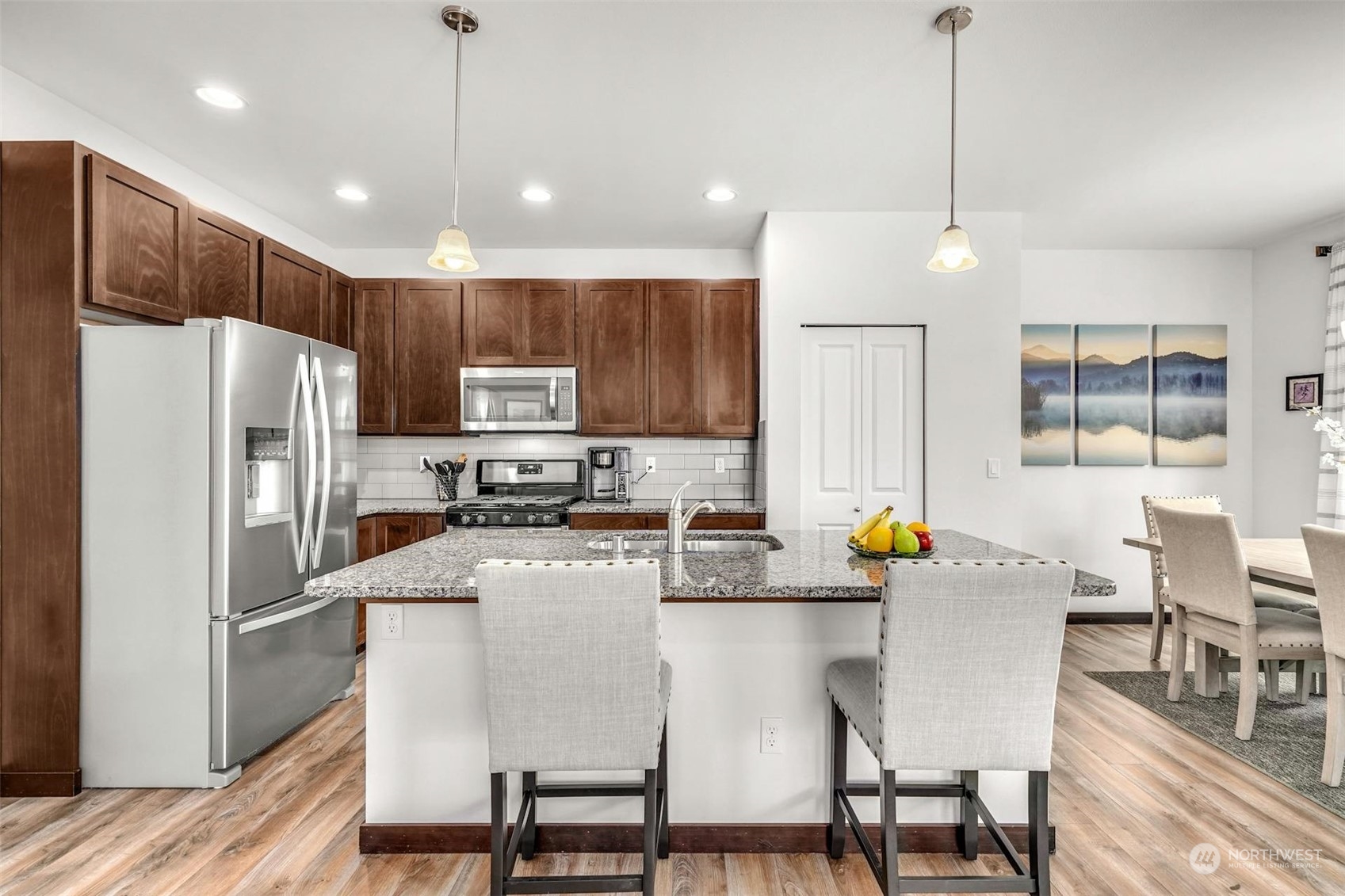 17801 3rd Avenue Southeast Bothell, WA 98012 - Photo 9 of 40 a kitchen with stainless steel appliances a dining table chairs refrigerator and microwave