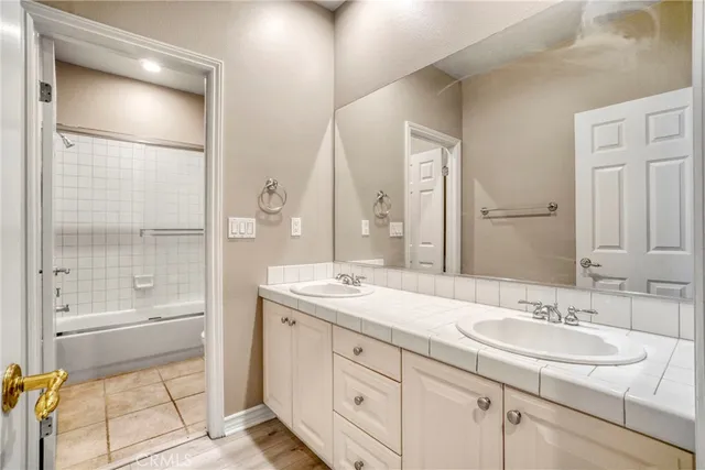 a bathroom with a sink double vanity and a mirror