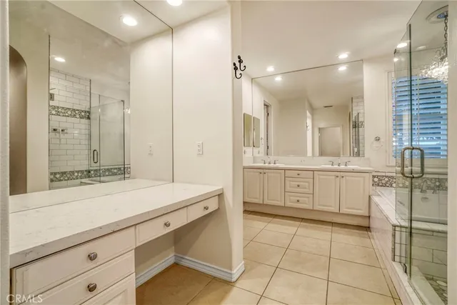 a bathroom with a shower sink and mirror