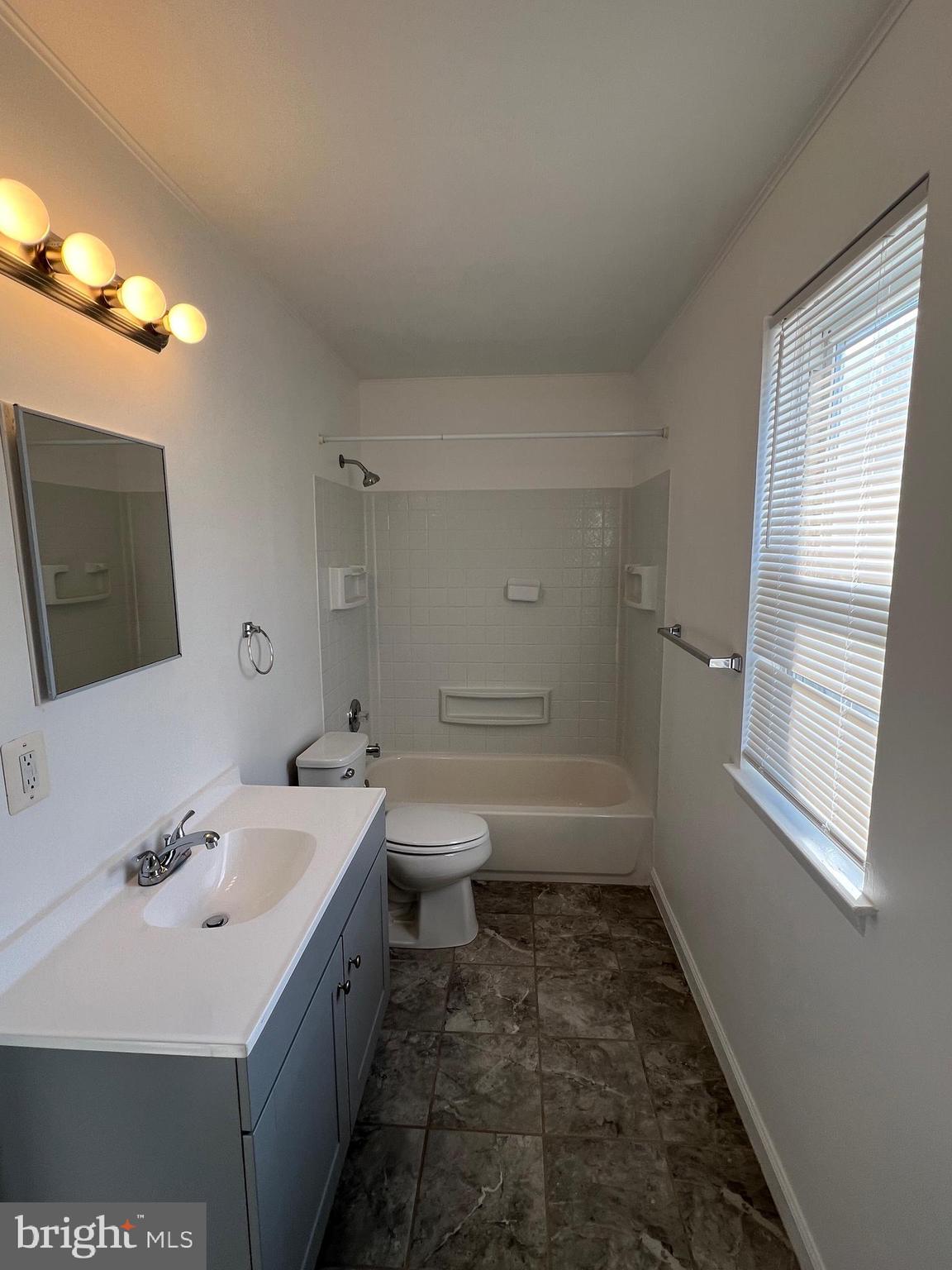 55 Noble Road Sicklerville, NJ 08081 - Photo 12 of 22 a bathroom with a sink a toilet and shower