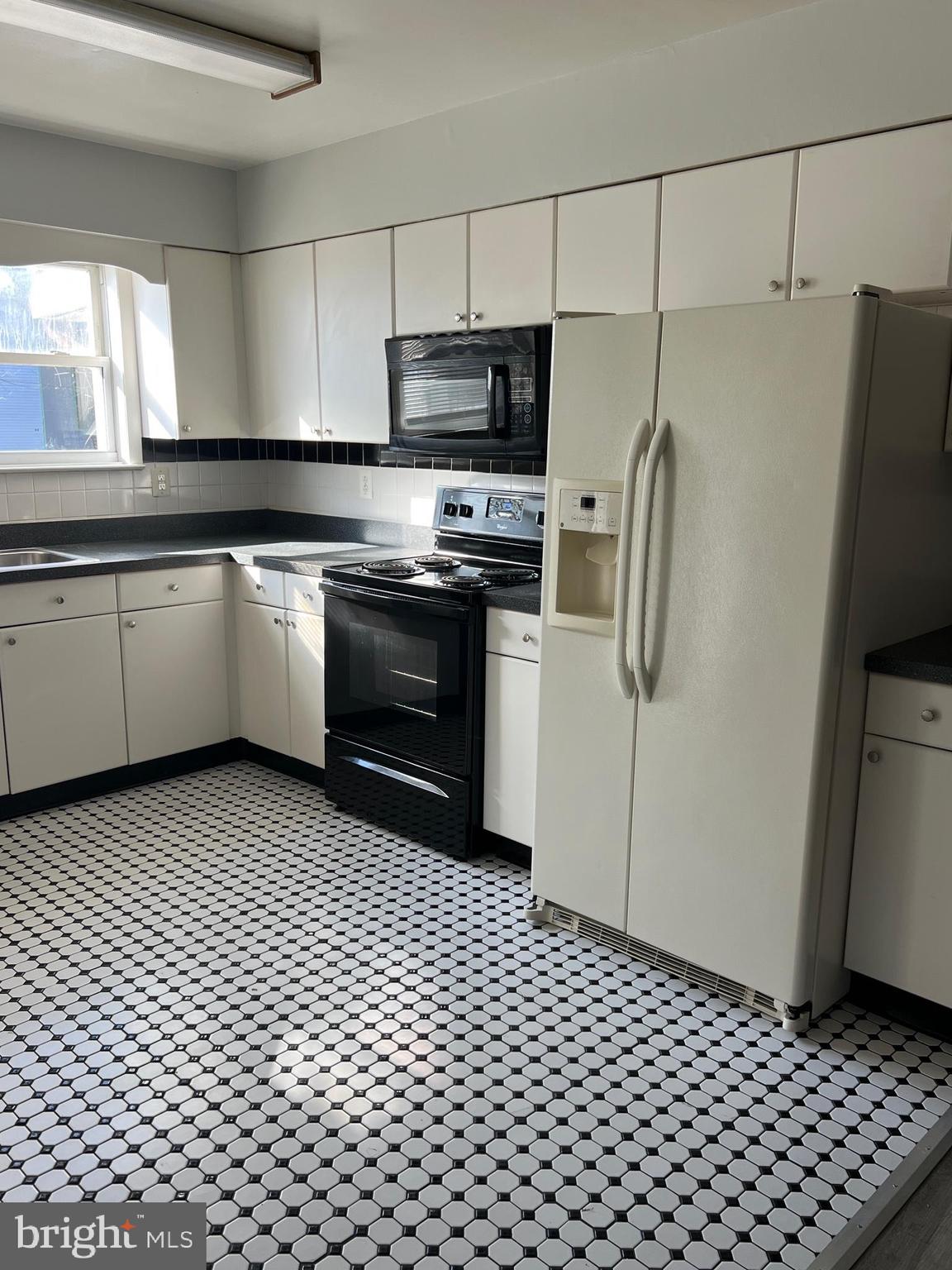 55 Noble Road Sicklerville, NJ 08081 - Photo 20 of 22 a kitchen with a refrigerator a stove a microwave and cabinets