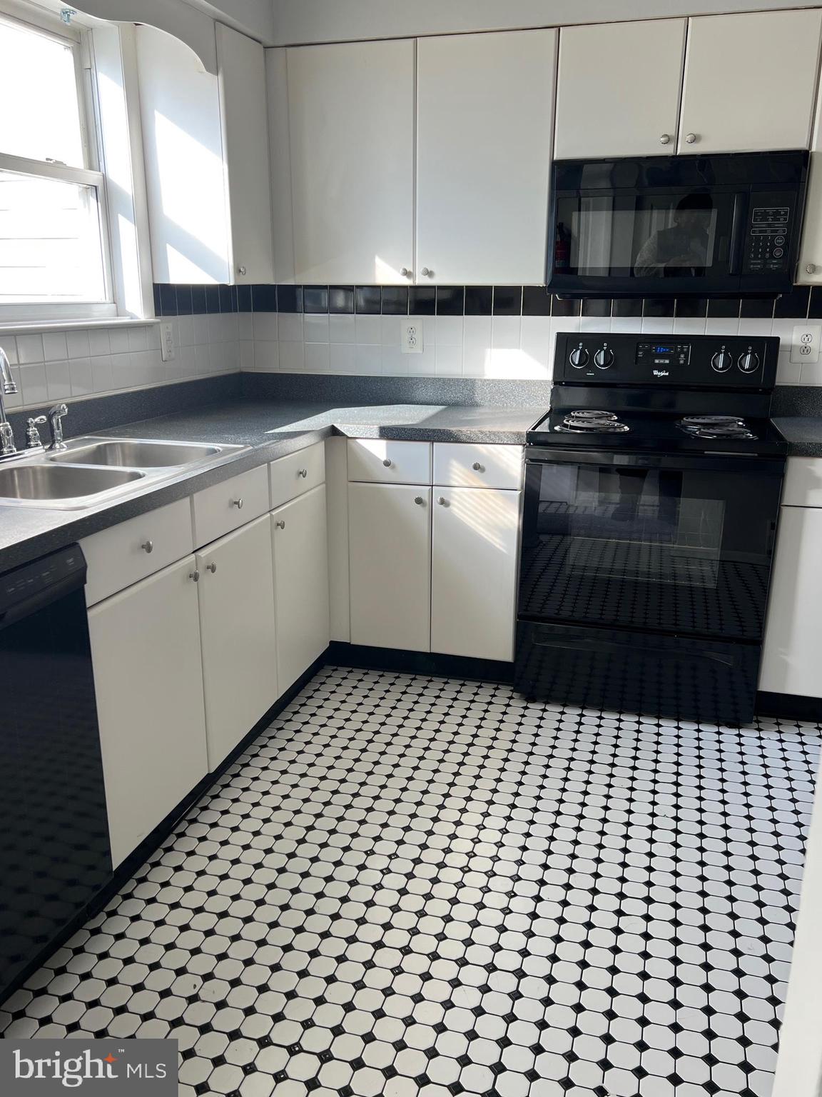 55 Noble Road Sicklerville, NJ 08081 - Photo 21 of 22 a kitchen with a sink and a stove