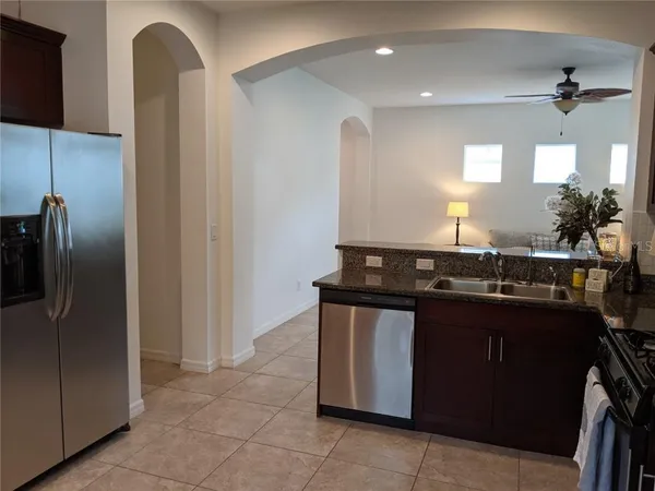 a kitchen with a sink a counter space appliances and cabinets