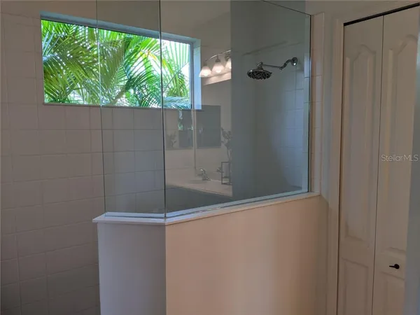 a bathroom with a glass shower door