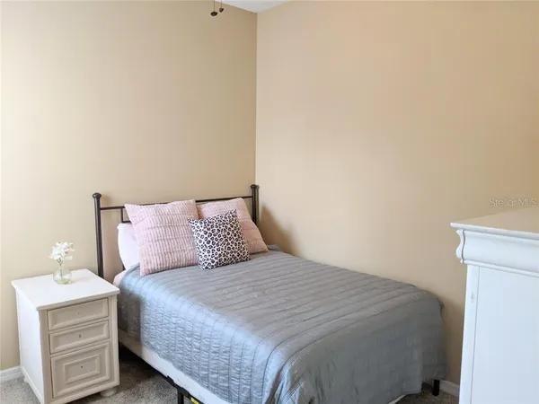 a bedroom with a bed and a night stand