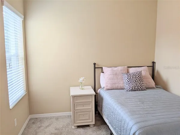 a bedroom with a bed and window