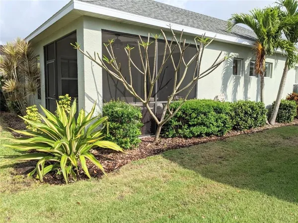 a view of a house with a flower garden