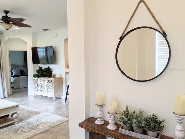 a living room with furniture and a mirror