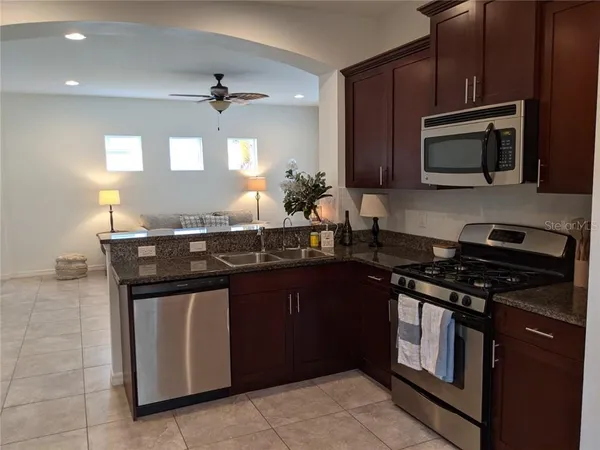 a kitchen with a sink stove and microwave